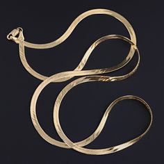 This vintage necklace (circa 1980-1990) features a chain of 14k gold herringbone links. The piece measures 24 inches long and weighs 8.4 grams. It is in great condition. Materials: 14k gold. Classic Gold Link Herringbone Necklace, Gold Classic Herringbone Link Necklace, Gold Herringbone Chain Necklace For Formal Occasions, Yellow Gold Herringbone Necklace With Snake Shape Chain, Gold Formal Herringbone Necklace, Formal Gold Herringbone Chain Necklace, Formal Gold Herringbone Necklace, Classic Gold Herringbone Chain Necklace, Classic Gold-plated Herringbone Necklace