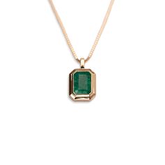 Our 14k Emerald Bezel Necklace features a lustrous and stunning genuine emerald forged in 14k yellow gold. We love the enhanced statement that this setting makes with its thick layer of gold perfectly bordering the natural emerald cut stone. 14k Solid Gold and Genuine Emerald Approximately 1.5 CTW Available as a pendant only, or with our 14k Cable Chain or Box Chain Available in lengths 16", 18", and 20" Due to the handmade nature of this necklace, please allow 1 - 3 weeks for processing. Bezel Necklace, Solid Gold Chains, Zambian Emerald, Natural Emerald, Box Chain, Chain Pendants, Fast Fashion, Emerald Cut, Cable Chain