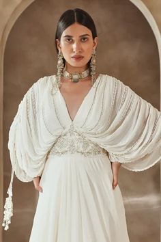 Shop for Seema Thukral Ivory Georgette Draped Bodice Embroidered Gown for Women Online at Aza Fashions Elegant Embellished Draped Gown, White Hand Embellished Gown Traditional Drape, White Hand-embellished Gown With Traditional Drape, Pre-draped Floor-length Wedding Gown, White Formal Dress With Traditional Drape, Festive Floor-length White Evening Dress, Festive White Floor-length Evening Dress, White Dress With Cape Sleeves For Reception, Elegant Draped Hand Embellished Dresses