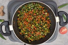 a pan filled with vegetables sitting on top of a stove