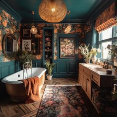 an ornate bathroom with green walls and floral wallpaper on the walls, along with a claw foot tub