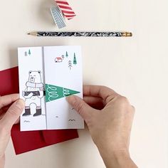 someone is making a christmas card out of paper