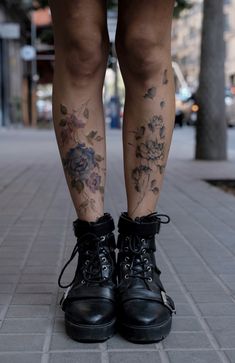 a woman's legs with tattoos on them