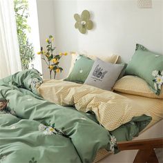 a bed with green sheets and yellow pillows