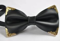 Welcome to Osunworld! Item : Black Faux leather Bow tie with gold edge Condition : Brand New Color: Black and Gold  Material: Faux Leather Size :120mm*65mm /4.75*5.26inch            Adjustable strap ,one size fits most Style : pretied  Package: 1 Bow tie Due to the use of flash photography, there may be slight or no color variation of item described   Payment Payments options: ETSY PAYMENT   Shipping Product will be shipped within 24 Hours of receiving cleared payment. You will receive our confirmation email 1  to 6 working days in Australia If you bought on Friday, the item may be delivered longer than usual, since the following 2 days (Saturday and Sunday)are not working days. Once you buy the item near the Public holiday, such as Christmas and Easter, it may takes longer time to arrive Luxury Satin Bow Ties For Business, Adjustable Gold Bow Tie For Party, Gold Adjustable Suit And Tie Accessories For Party, Formal Gold Suit And Tie Accessories With Decorative Bow, Gold Bow Tie For Party, Elegant Gold Bow Tie For Party, Elegant Gold Ties For Party, Bowtie Wedding, Leather Bow Tie