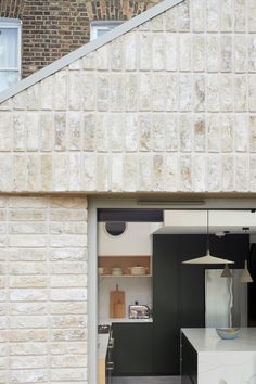 an open door leading to a kitchen and dining area with white counter tops on the outside