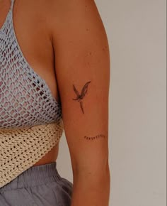 a woman with a small tattoo on her arm