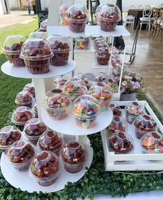 there are many desserts on the table and in plastic containers for sale at this event