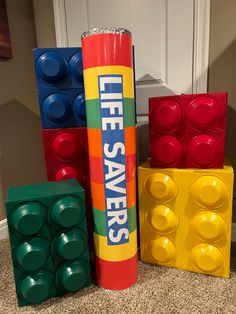 there are legos stacked on top of each other in front of a door with the words life savers written on it