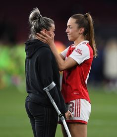 two female soccer players congratulate each other on the field