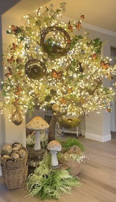 a tree that is decorated with lights and mushrooms in the middle of a room filled with plants