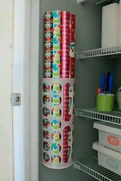 rolls of toilet paper are on the shelf in the closet next to the refrigerator door