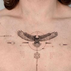 a woman's chest with an owl and geometric shapes on the top half of her chest