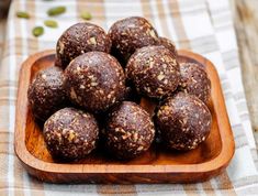 a wooden plate filled with chocolate balls on top of a table