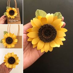 the sunflower has been made from paper and is being held by someone's hand