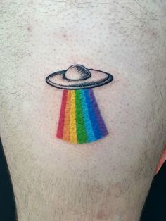 a man with a rainbow tattoo on his chest and an alien spaceship in the center