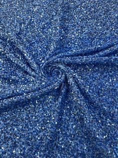 the fabric is blue with silver glitters on it