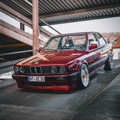 a red car parked in front of a building