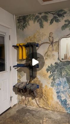 a room with wallpaper that has birds on it and trees painted on the walls