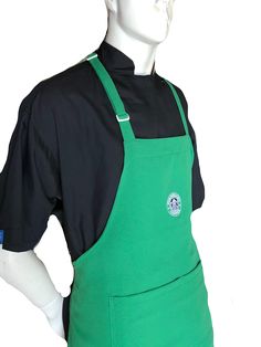 a mannequin wearing an apron with a green bib and black shirt on it