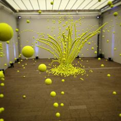 yellow balls are floating in an empty room