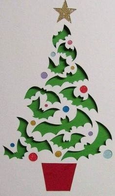 a christmas tree made out of paper on top of a white board with gold stars