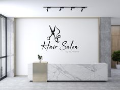 a hair salon with scissors on the wall and marble counter top in front of it