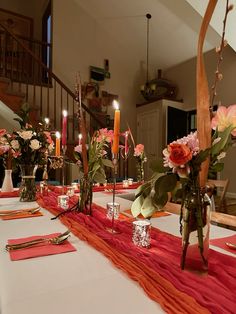 the table is set with candles, flowers and napkins for dinner guests to enjoy