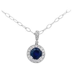 Our fine jewelry collection now includes a stunning sapphire gemstone pendant necklace that is sure to add a touch of elegance and sophistication to any outfit. This exquisite necklace is designed with a beautifully crafted 18K white gold chain that shimmers in the light and features a gorgeous round sapphire gemstone at the center, weighing 4.00 carats. The sapphire is surrounded by a halo of white round diamonds with a total weight of 0.80 carats, adding a touch of sparkle and brilliance to th