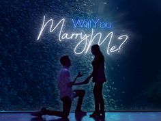 two people sitting on the floor in front of a wall that says, why you marry me?