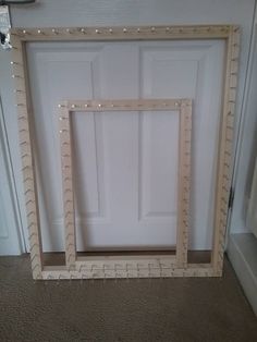 an empty white door in the corner of a room next to a window with beaded trim