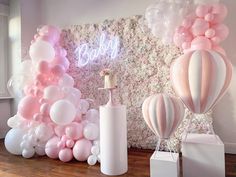 balloons and candles are on display in front of a wall