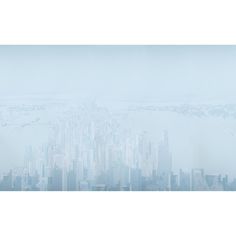 an aerial view of a large city in the foggy day with water and buildings