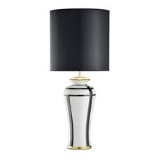 a table lamp with a black shade on the base and a gold trimming around it