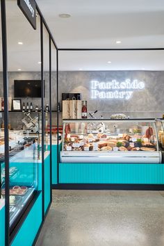 the inside of a pastry shop with blue walls