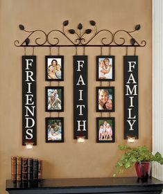 a family photo hanging on the wall above a mantle with candles and pictures attached to it