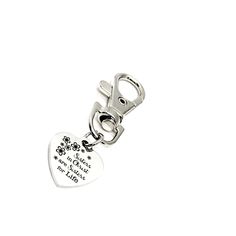 a heart shaped keychain with a dog's paw print on it