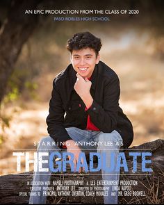 a young man sitting on top of a log