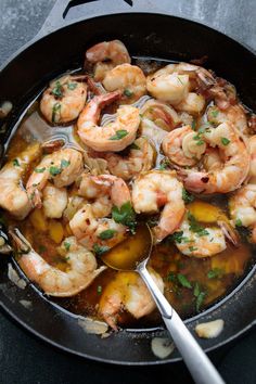 a skillet filled with shrimp and sauce