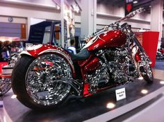 a red motorcycle on display in a building