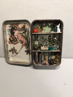 an open tin box filled with assorted items