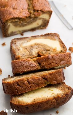 slices of banana bread on a cutting board with butter in the center and one slice cut off