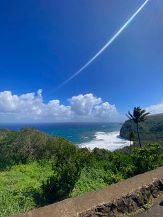 the view from top of a hill looking out at the ocean