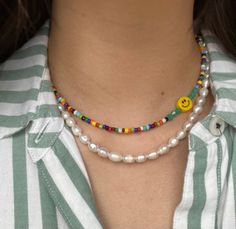 This beaded necklace is perfect for brightening up any outfit! Dress it up for a more elegant night out, or wear it casually for a chic, beachy look. Perfect for the summer months or a touch of fun during an overcast winter day. This necklace is made out of 6mm  yellow happy face beads and rainbow seed beads, finished with silver hardware. Necklace Length: 14.5 inches- We add a 2in extender chain at the end to make the necklace adjustable (14.5 inches - 16.5 inches)- If you would like a differen Hardware Necklace, Pearl Beaded Necklace, Single And Happy, Rainbow Jewelry, Necklace Pearl, Summer Necklace, Outfit Dress, Necklace Beaded, Jewelry Outfit