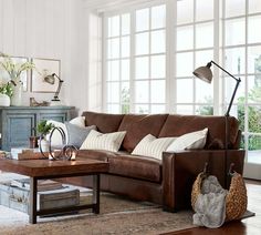 a living room filled with lots of furniture and decor on top of a wooden floor