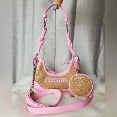 -Pink Fondant Straw/Wicker Crossbody Bag With Pink "Steve Madden" Logo Charm On The Front -Comes With Adjustable/Detachable Crossbody Strap And Has Faux Leather Shoulder Strap (Shoulder Strap Attachment Can Be Taken Off) -Bag Can Be Worn As A Crossbody Bag, Shoulder Bag, Or As A Handbag -Inside Bag Has One Zippered Wall Pocket With One Sleeve Pocket -Zipper Closure -All Silver Hardware Accents -New With Tags. No Damages Dimensions: W:8½" H:4" D:2½" Casual Pink Baguette Bag For Travel, Pink Crossbody Baguette Bag With Mobile Phone Pocket, Pink Crossbody Baguette Bag With Mobile Phone Bag, Trendy Pink Crossbody Baguette Bag, Pink Crossbody Baguette Bag With Detachable Strap, Pink Baguette Bag With Detachable Strap For Shopping, Pink Baguette Bag With Detachable Strap For Travel, Pink Crossbody Shoulder Bag For Errands, Trendy Pink Pouch Baguette Bag