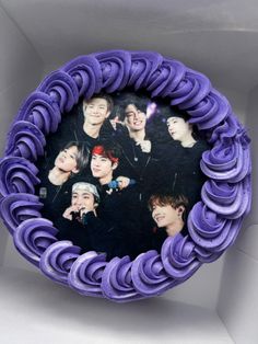 a purple cake decorated with photos of btob members