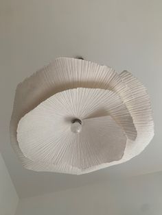 two large white umbrellas hanging from the ceiling