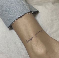 a woman's arm with a small heartbeat tattoo on the left side of her wrist