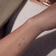 a person with a small star tattoo on their arm